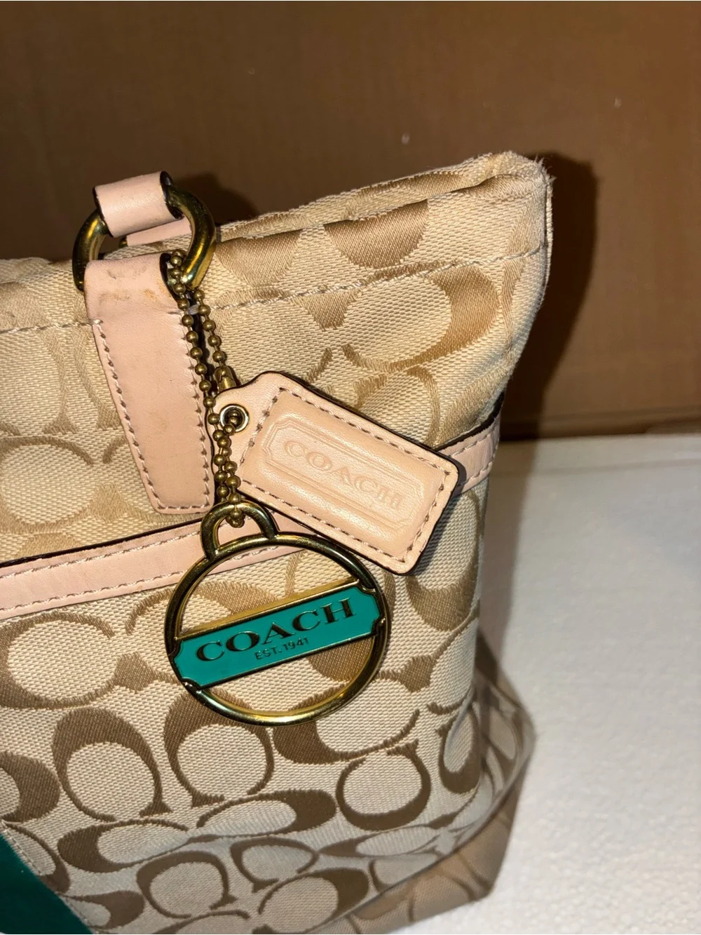 COACH Beige Signature Tote with Teal Center Stripe.